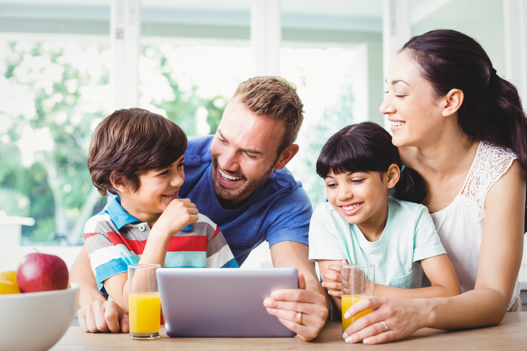 Happy family using digital tablet