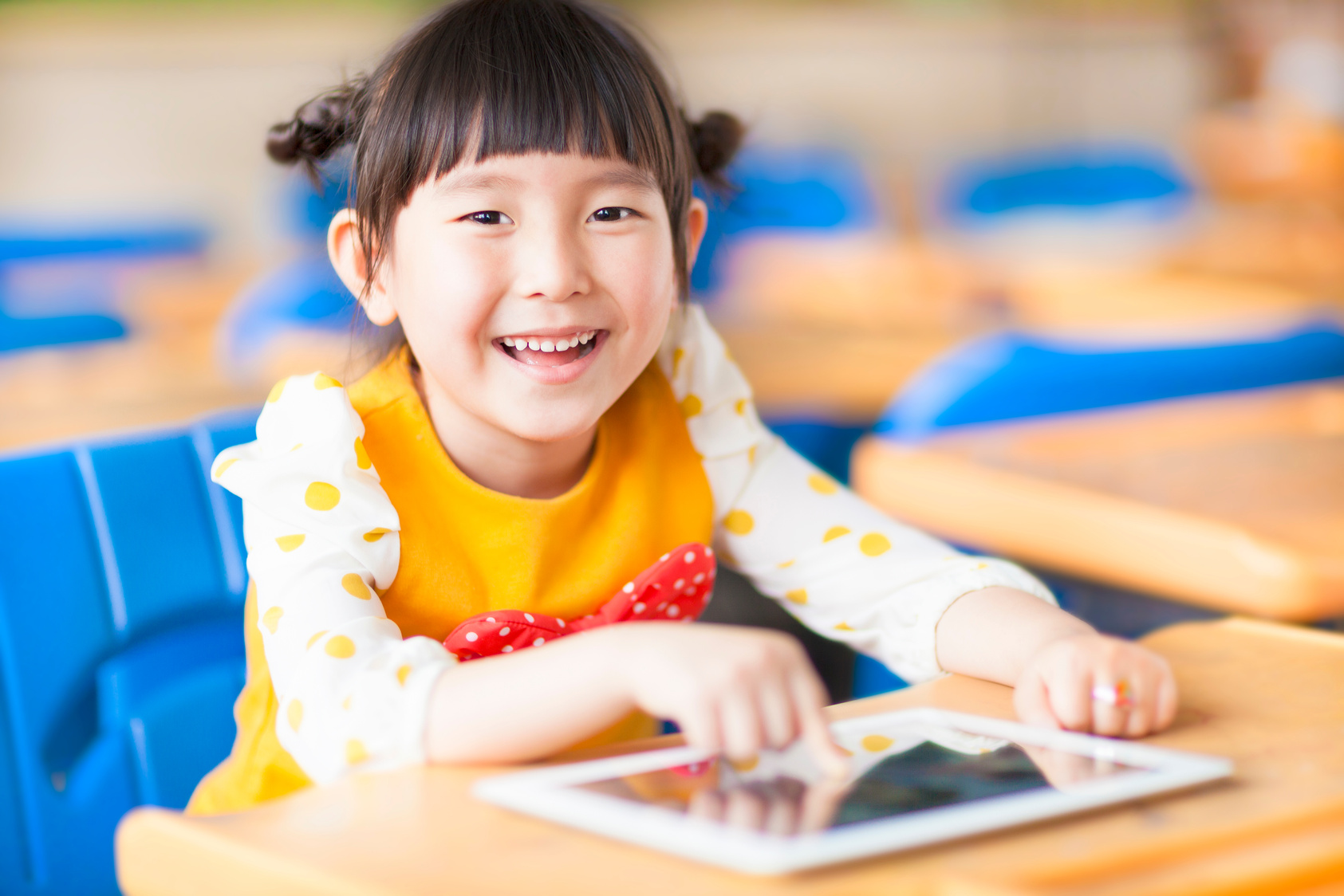 smiling kid using tablet  or ipad